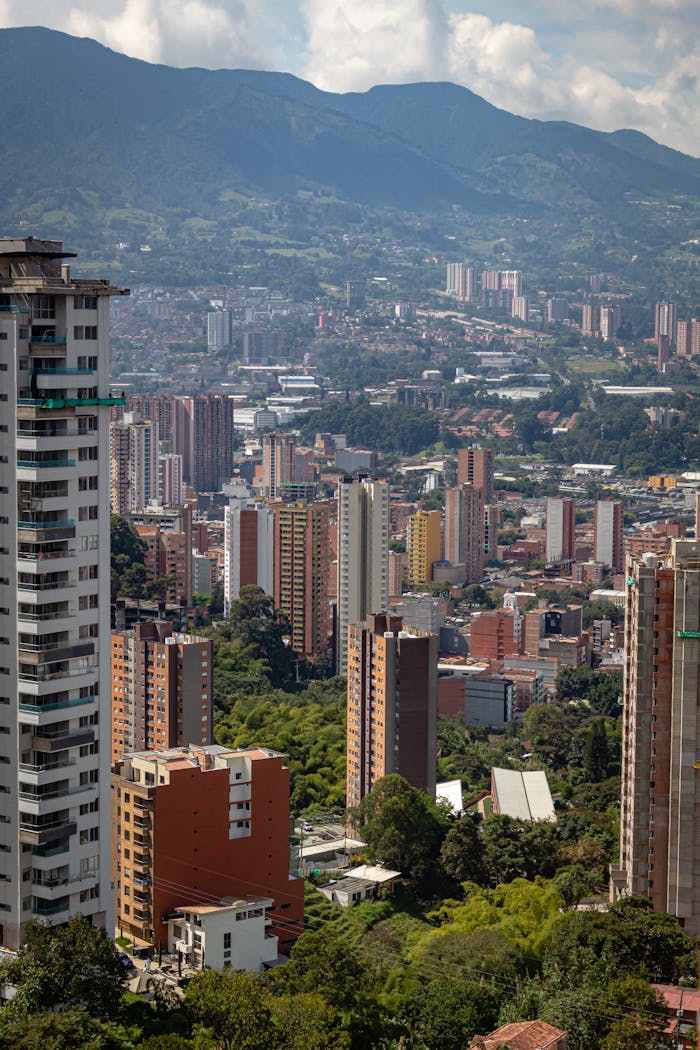 A stunning aerial cityscape of Medellín, Colombia framed by mountain ranges.
