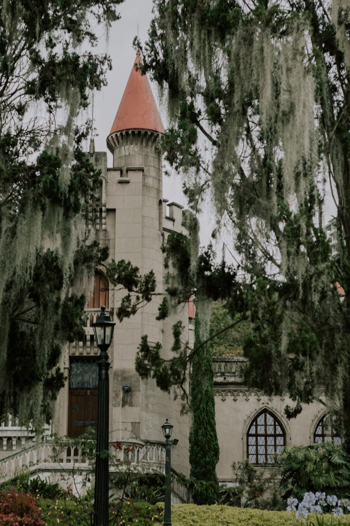Medieval-style castle tower surrounded by lush greenery in Medellín, Colombia.
