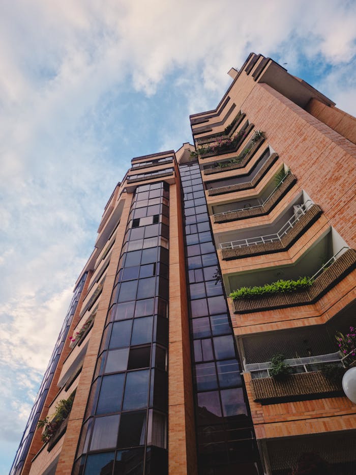 Low-angle shot of a modern high-rise building with balconies and glazed windows in Bucaramanga, Colombia.